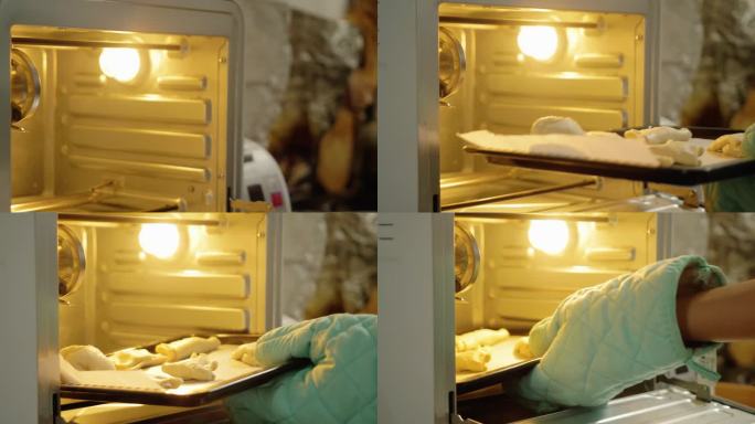 手拿烤箱手套将泡芙糕点托盘放入烤箱，准备在家烘烤。