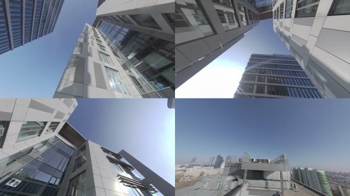 360度视野。蓝天映衬下的现代玻璃建筑的城市景观。FPV无人机