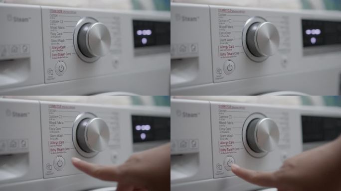 人类手指按下按钮关闭洗衣机的特写镜头