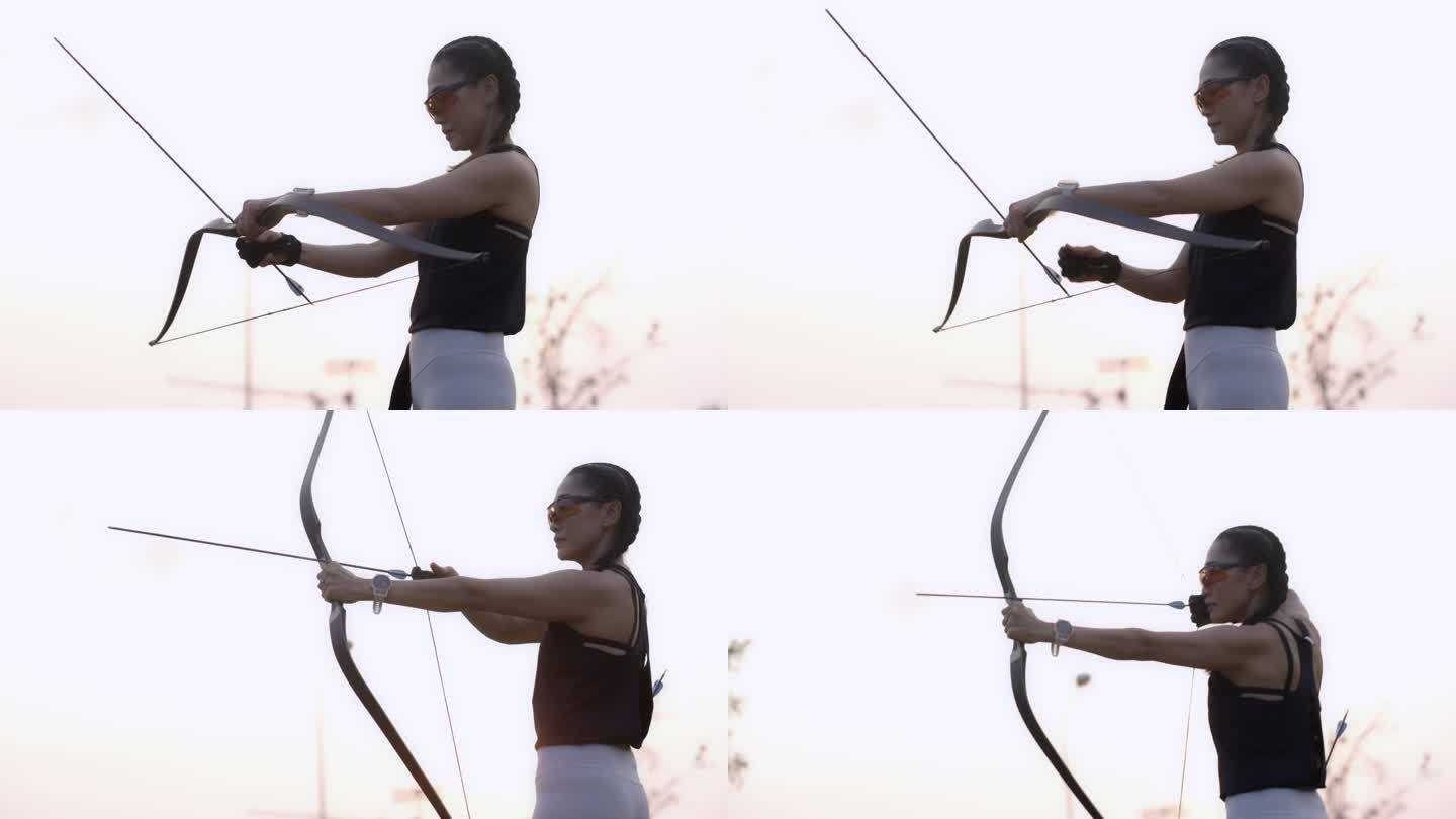 近距离拍摄在靶场练习射箭的迷人亚洲女性。