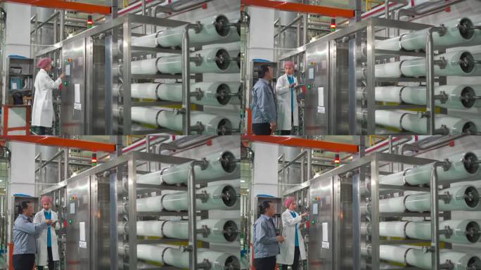 亚洲工厂经理与女工程师讨论在制造工厂实验室使用数字平板电脑