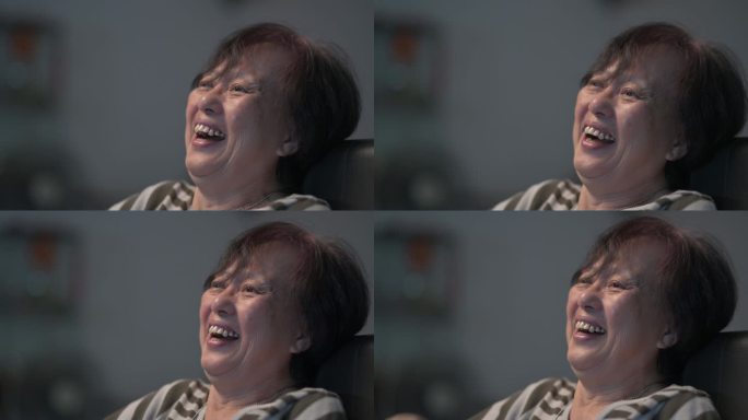 亚洲华人老年女性喜欢周末在家看电视，晚上独自一人在看喜剧电视剧