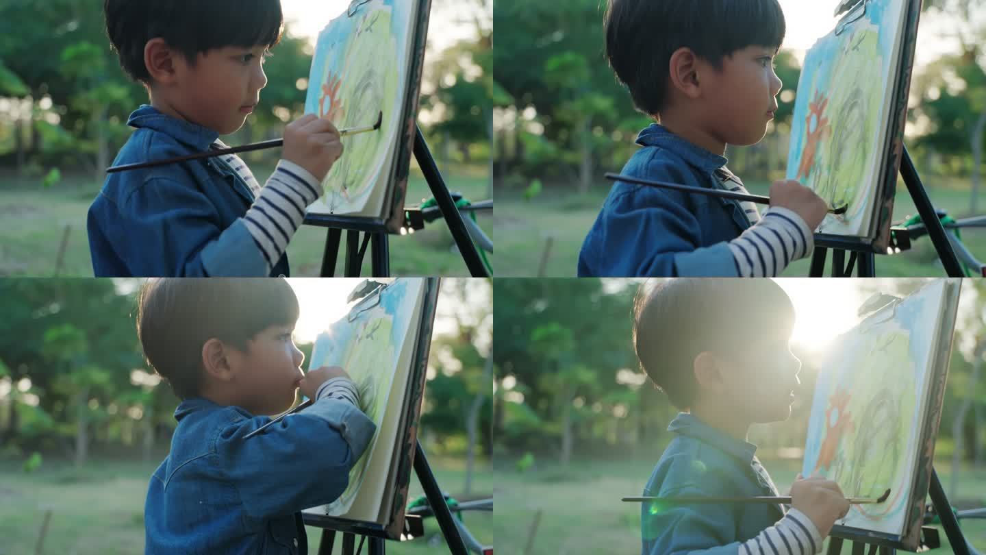 男孩在乡村和公园用水彩和画笔画画。