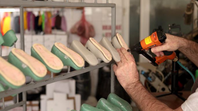 使用订书机枪的专业鞋匠，因此他可以将鞋底连接到鞋模型