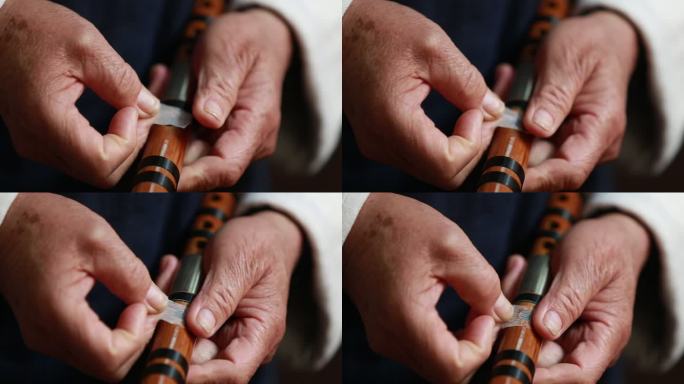 老人皱纹双手贴竹笛横笛笛子竹衣特写实拍