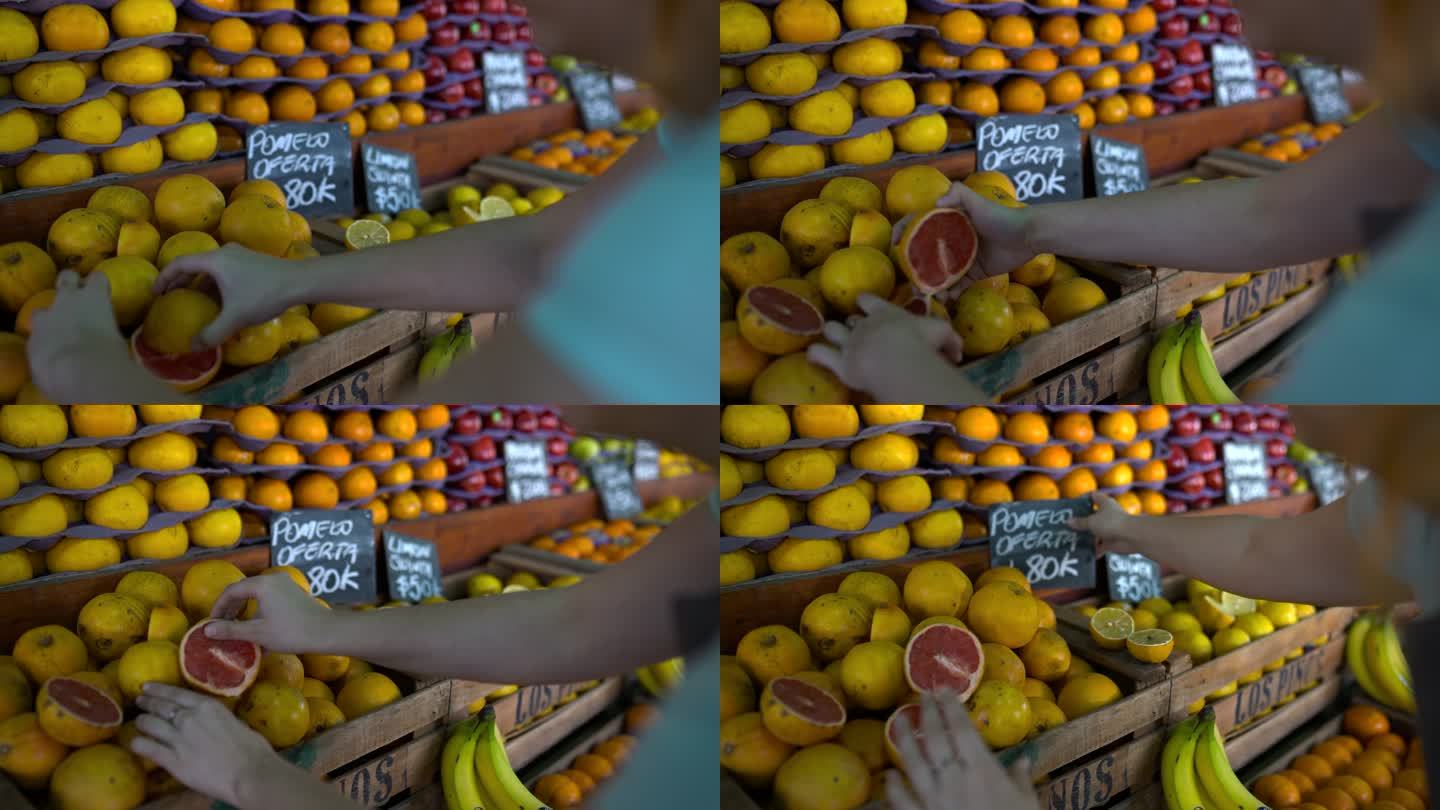 一位面目全非的女售货员正在农贸市场的摊位上布置水果展示
