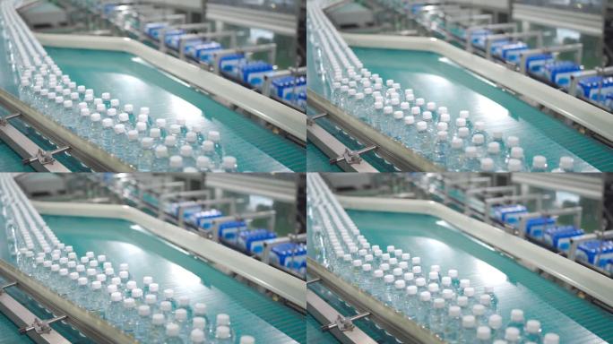 矿泉水工厂生产线：将瓶子装在传送带上，然后在装货区用纸箱包装