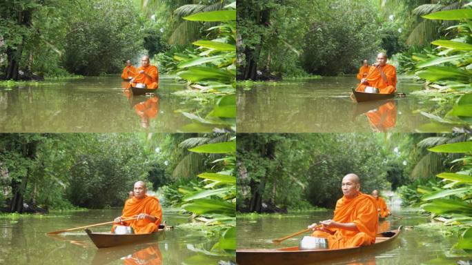 早上，泰国僧侣在运河里划船施舍。为僧侣提供食物的传统东南亚文化，泰国，曼谷