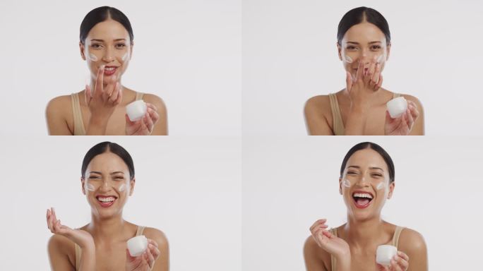一个美丽的年轻女子在脸上涂抹保湿霜的4k视频片段