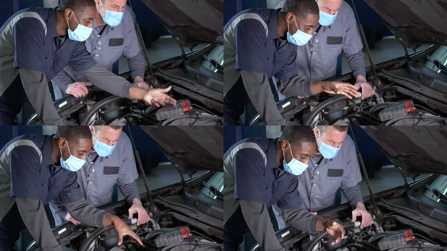 多民族机械师戴口罩检查汽车发动机