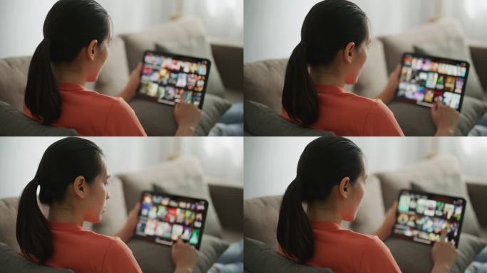 女人在平板电脑上浏览互联网看电视电影