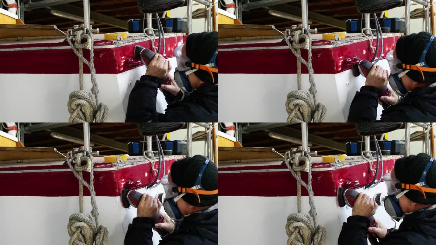 男子在船屋使用磨床、DIY、维护帆船