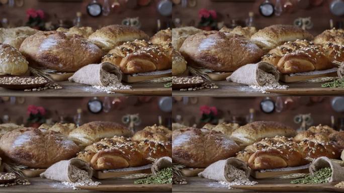 慢镜头中一组新鲜面包和烘焙食品的全景特写。手工面包店