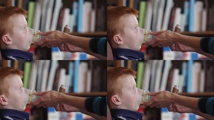 小红发男孩接受母亲的呼吸哮喘治疗