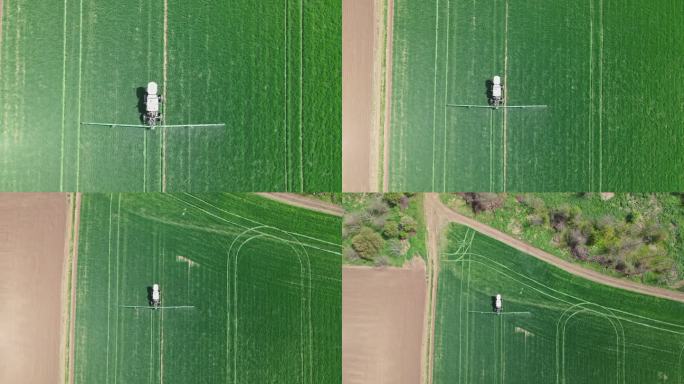 拖拉机为绿色麦田施肥的鸟瞰图。