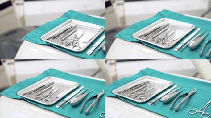 淘洗：无菌牙科设备、手术剪刀、钳子、牙根提升器和骨膜，为牙科医生准备绿色无菌窗帘