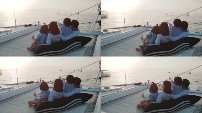 快乐的亚洲家庭在日落的游艇上度过美好时光