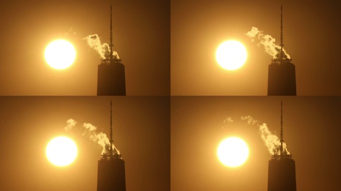 摩天大楼蒸汽夕阳下的烟环境污染逆光