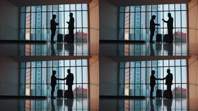 一个商人和女商人在一间有巨大窗户的大办公室里互相交谈的剪影