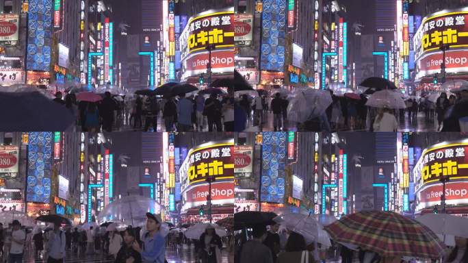 在涩谷，人们手持雨伞划过马路