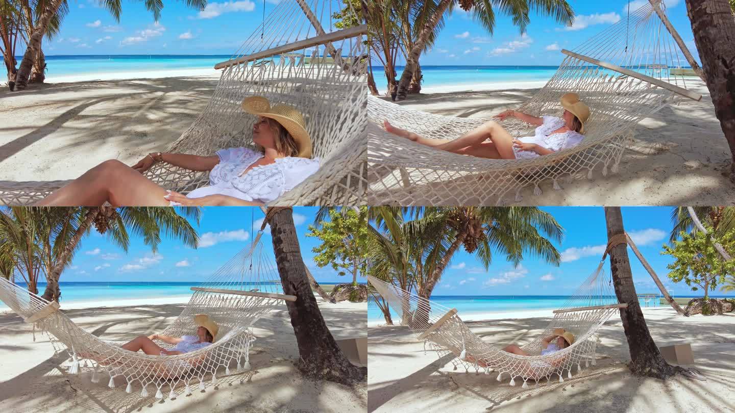 一名妇女在热带岛屿度假胜地的吊床上休息