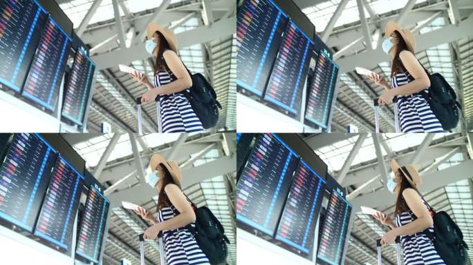 一个女人在看机场的登机牌