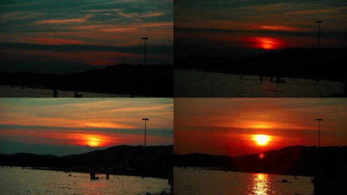 夕阳 火红的太阳 落日余晖 海边的人群