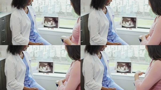 孕妇和医生检查超声图像