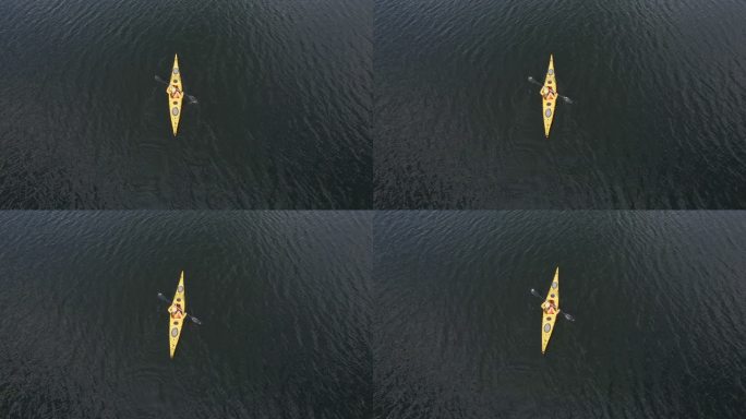高山湖泊中女子皮划艇的鸟瞰图。划船和生态旅游。