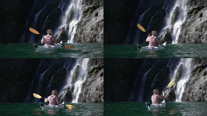 一名女子皮划艇运动员在瀑布附近的独角镜头