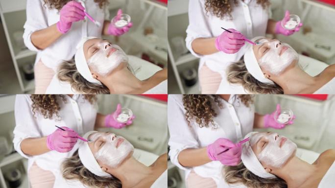 美容师在女性客户脸上刷口罩