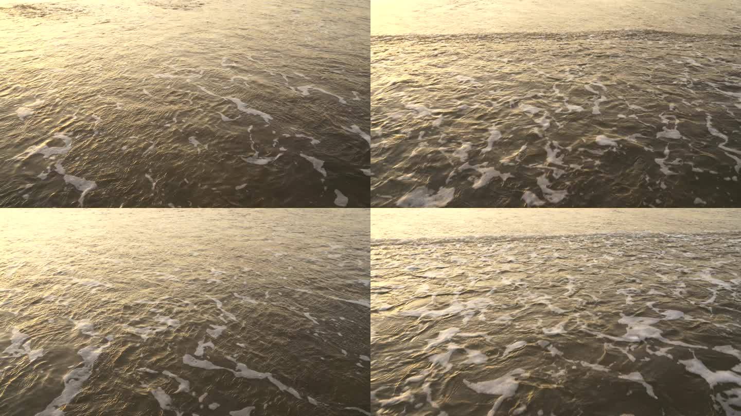 夕阳下水面金色海面波浪阳光沙滩海水冲刷击