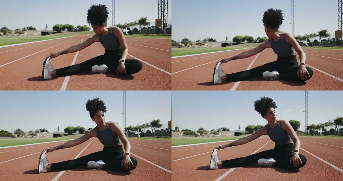 在跑道上跑步和在运动中心或体育场训练之前，在热身中有非洲伸展腿的运动员。专注，严肃，健康，运动女性坐