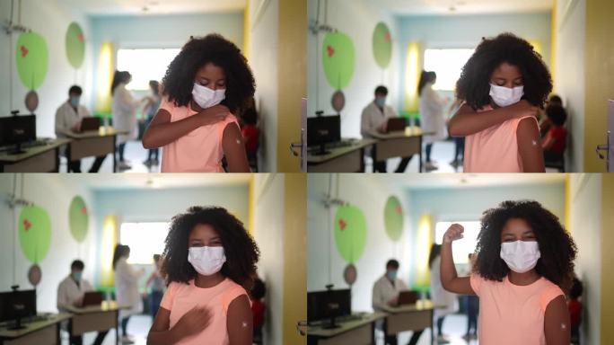 一个小女孩接种疫苗后露出手臂的肖像