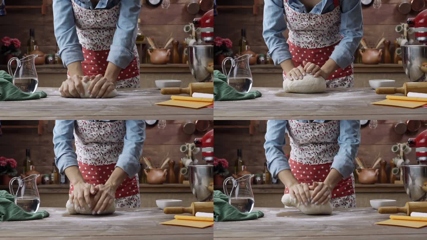 在乡村厨房里，一位年轻女子手揉面团制作面包。酸面包制作。