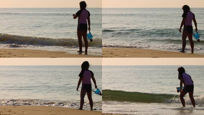 海边沙滩早晨傍晚周末小女孩在玩水