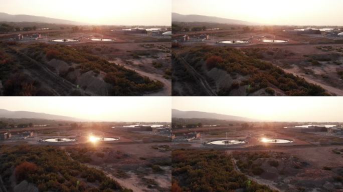 黄昏时分，接近科罗拉多州西部一座现代化废水处理厂的无人驾驶飞机，消化池上方有圆顶