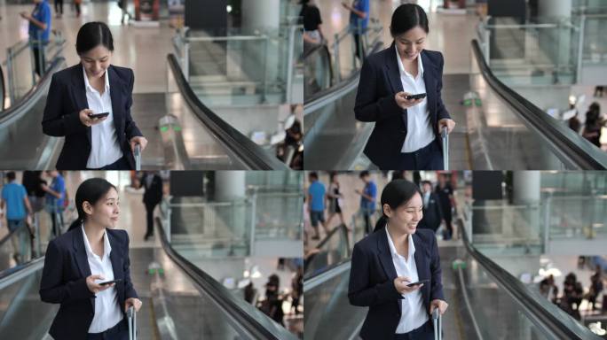 女商人在机场自动扶梯上使用电话