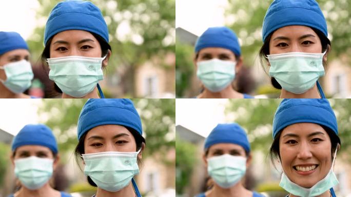 微笑的亚裔和高加索人医护人员戴着防护面罩
