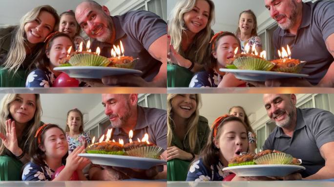 家庭在家庆祝女儿的生日-包括一个特殊需要的女孩-网络摄像头的观点