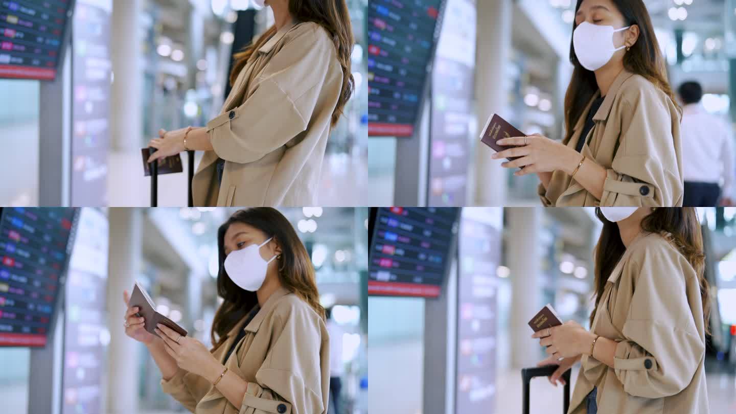 一个女商人戴着口罩在数字时刻表上检查登机时间。