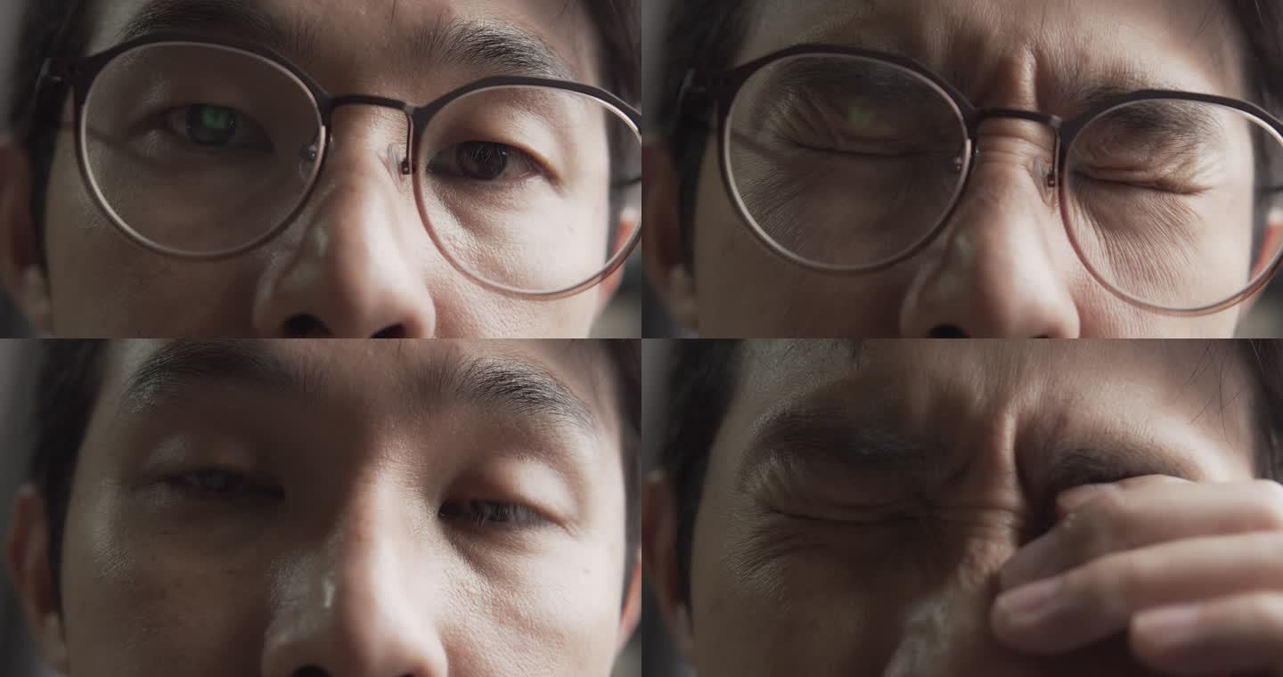一名戴眼镜的亚裔男子，由于在电脑上工作而感到压力或抑郁，眼睛疲劳。用电脑工作到很晚