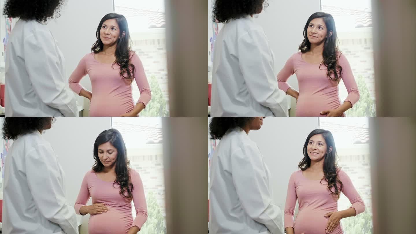 兴奋的孕妇在产前检查期间与妇产科医生交谈