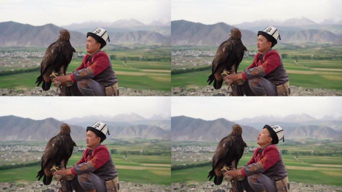坐在吉尔吉斯斯坦山脉背景上的猎鹰者