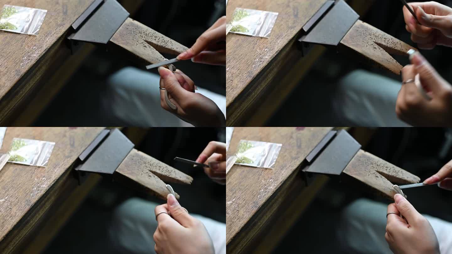 亚洲韩国女学生在大学工作台上使用手锯的手的高角度视图