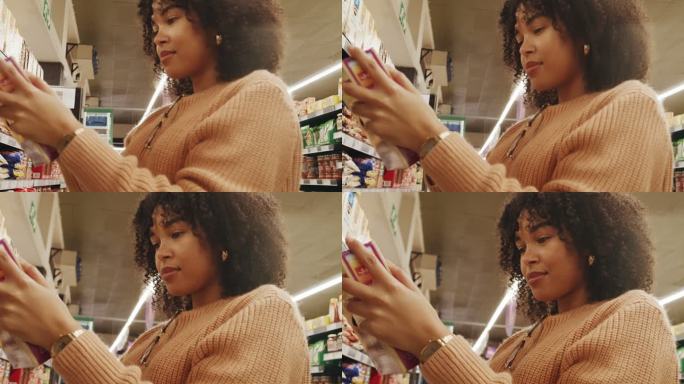 在超市购物的女人。一名年轻女性在商店里看着一个产品，读着标签。站在商店过道内选择谷物的人