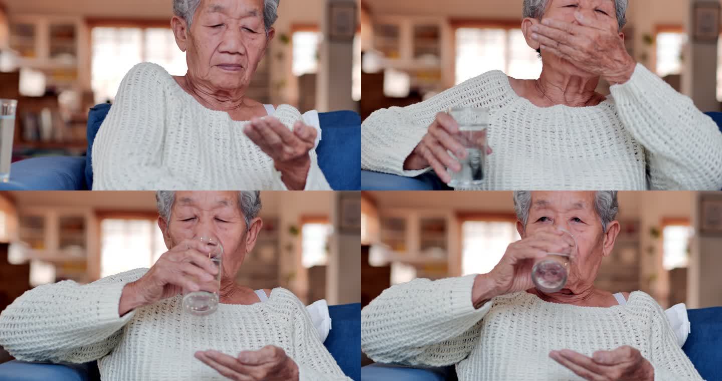 一位亚洲老年妇女感到不舒服，在家里吃药片或服用维生素。医疗、护理、退休、生活方式、医疗保健和医学、老