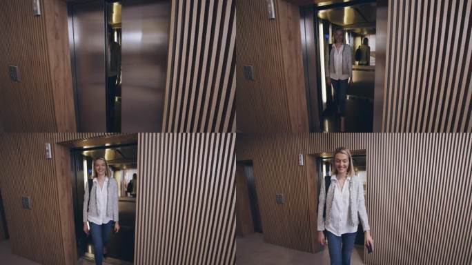 年轻的女商人走出电梯，进入办公室大厅