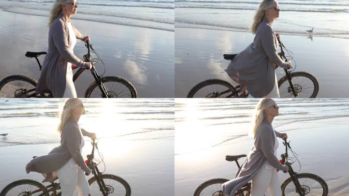 一名妇女在空荡荡的海滩上推着自行车