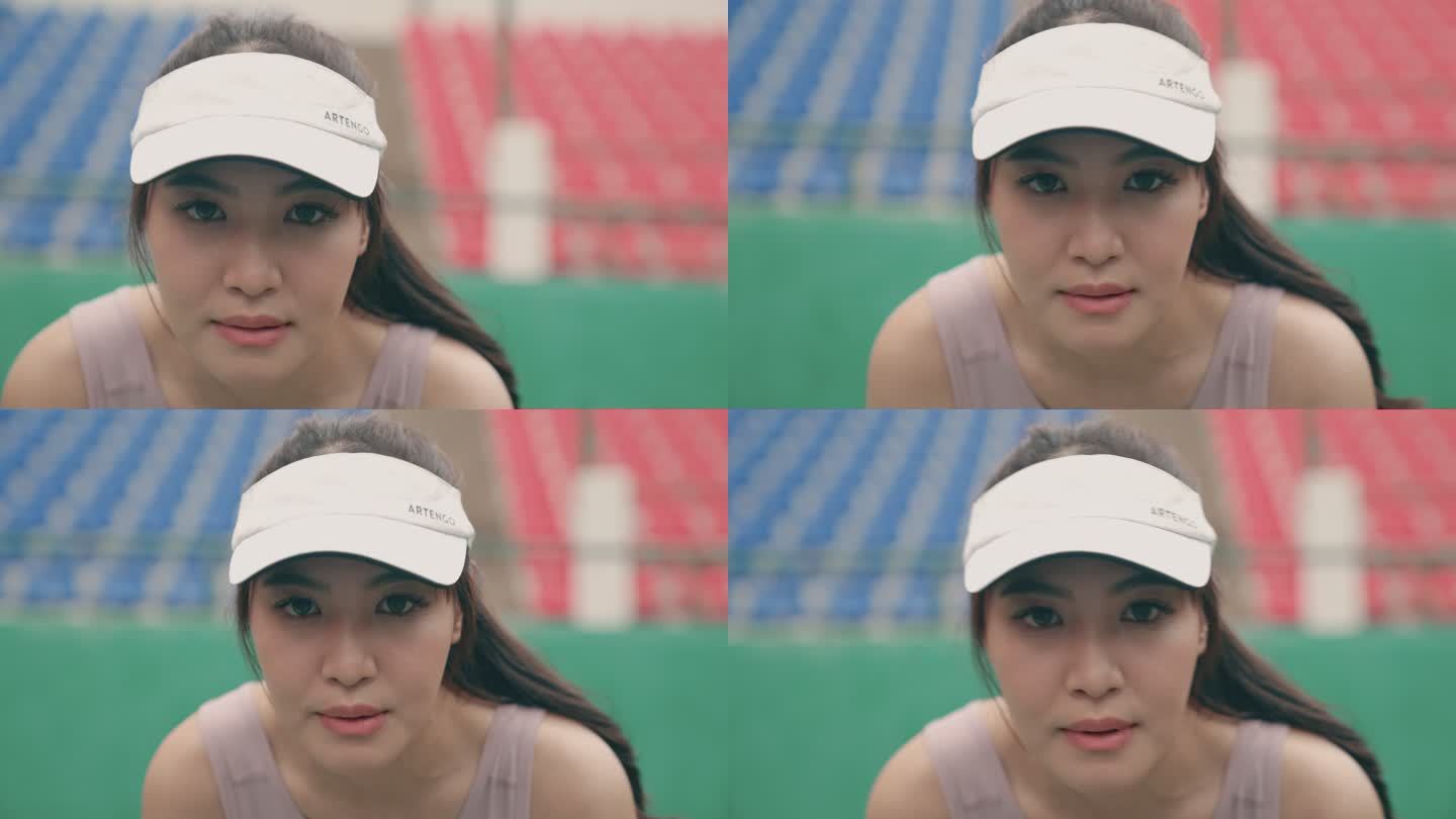 一位年轻的亚洲网球运动员，不断地移动，期待着她的朋友发球。